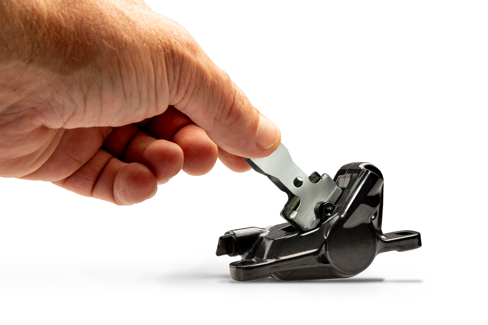 Person Inserting NRS1 Brake Pad into Caliper